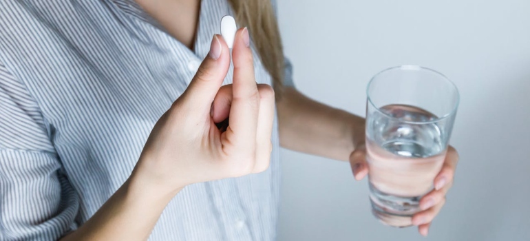 a woman taking a medicine