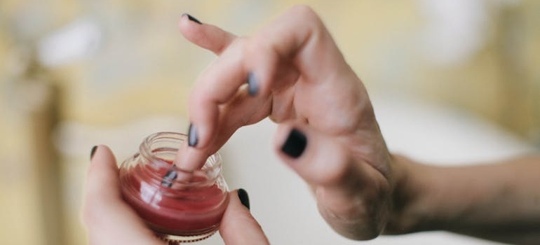 Woman applying ointment.