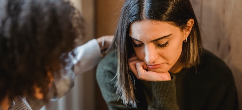 Woman supporting her friend who is dealing with social drinking vs alcoholism.