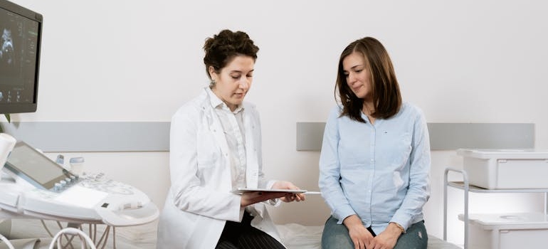 Pregnant woman talking to her doctor about treatment options.