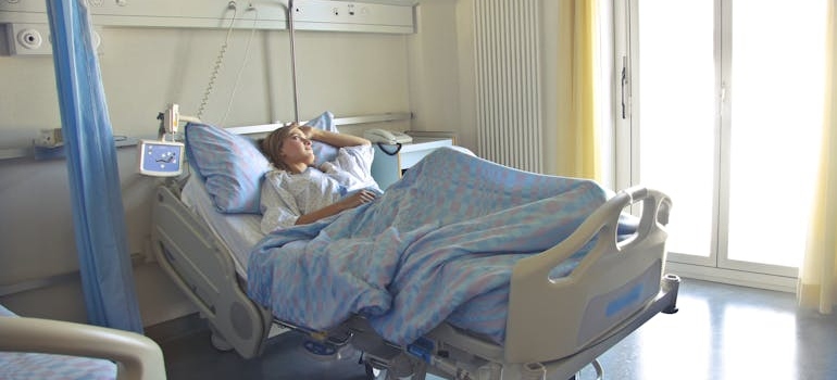 Woman lying in a hospital bed.