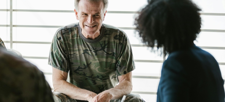 A veteran is sitting and talking to his therapist about why veterans struggle to seek rehab.