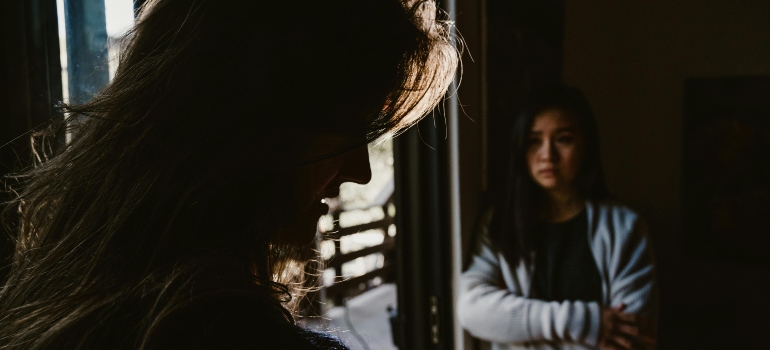 A worried woman is looking at the man and asking "Can you force someone into rehab"