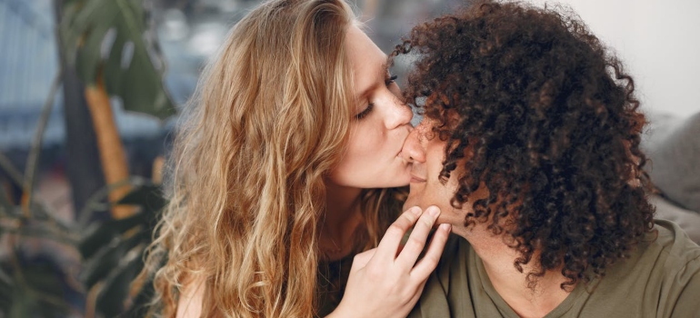 a woman kissing a man on the nose