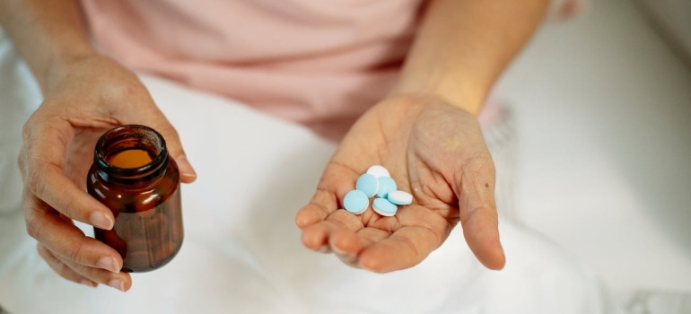 a woman taking a medicine