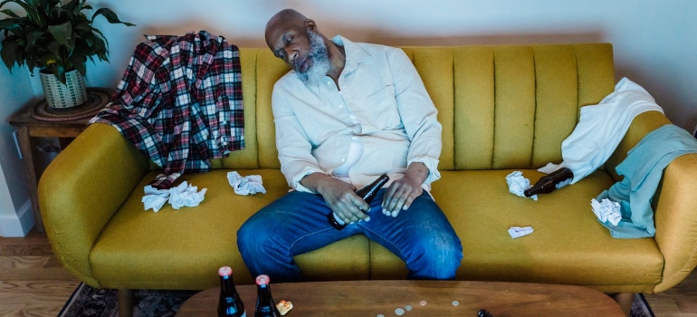 a man sleeping on a sofa after mixing Antipsychotics and Alcohol