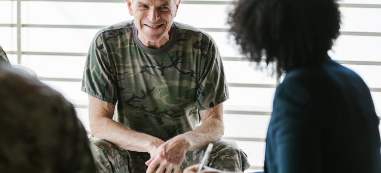 a veteran at rehab center talking to a woman