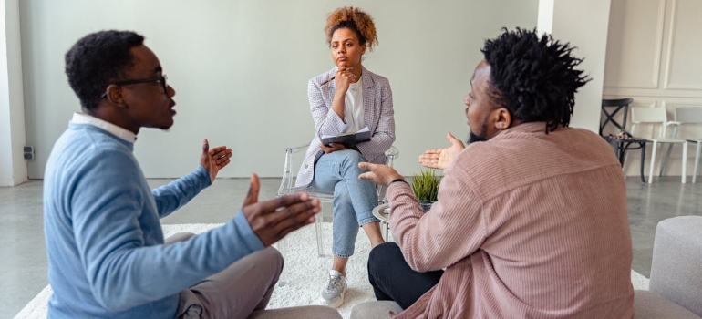 men arguing in a therapy session